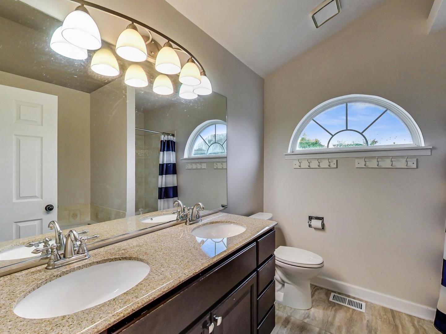 2385 North Periwinkle Way Round Lake Beach, IL 60073 - Photo 25 of 51 a bathroom with a sink and a mirror