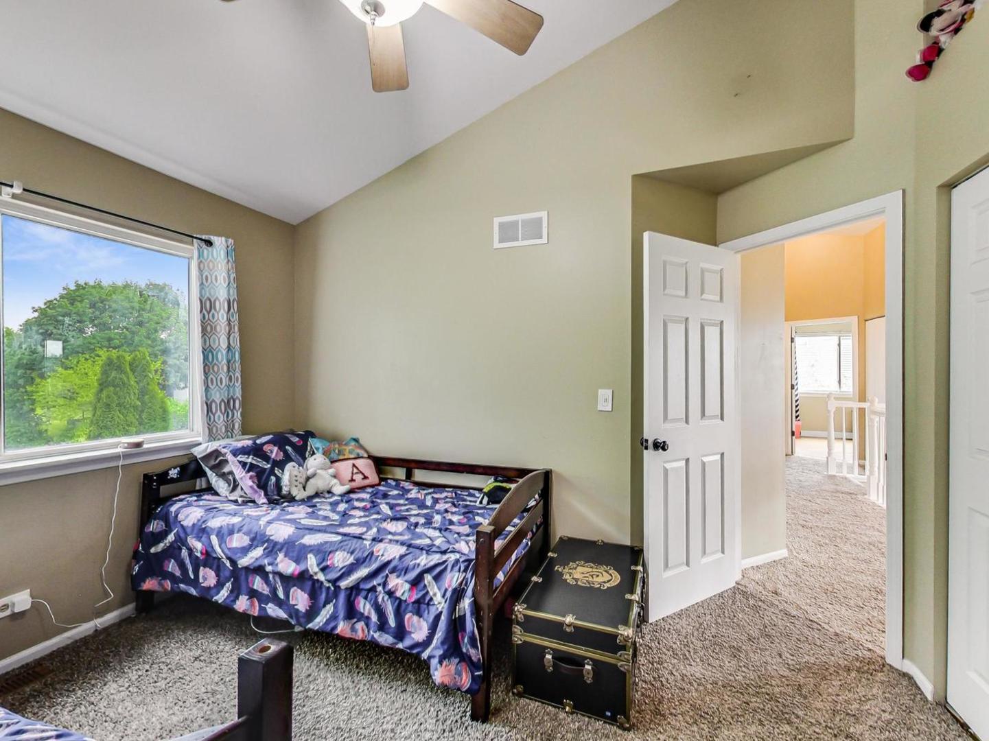 2385 North Periwinkle Way Round Lake Beach, IL 60073 - Photo 28 of 51 a bedroom with a bed and wooden floor