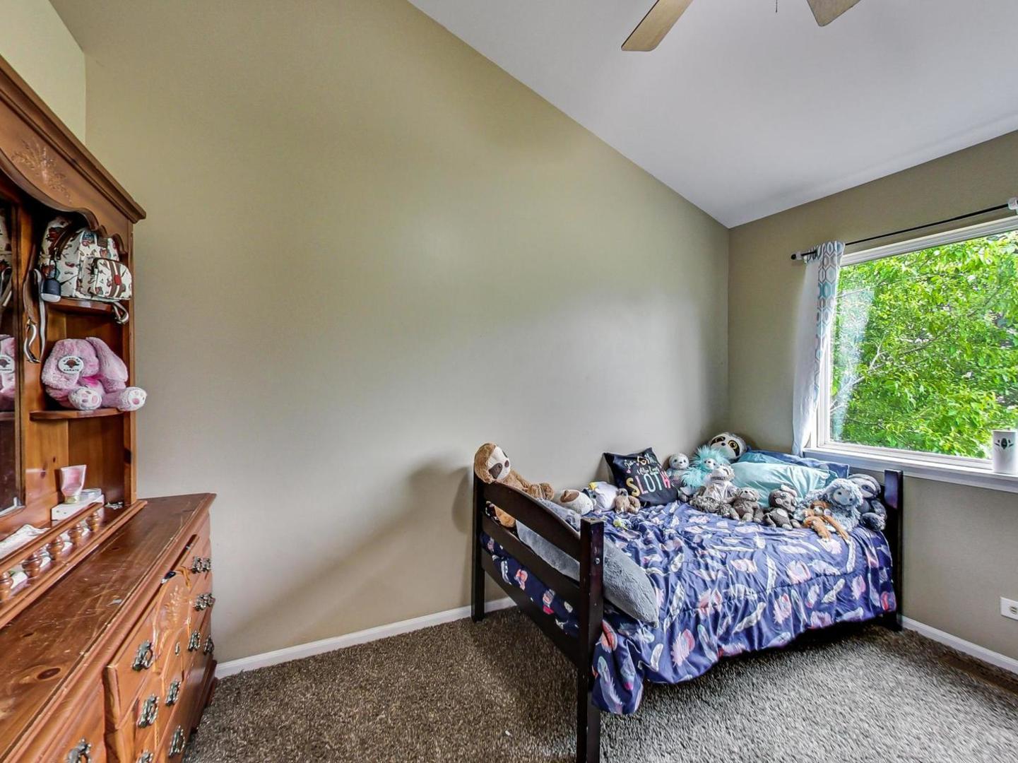 2385 North Periwinkle Way Round Lake Beach, IL 60073 - Photo 30 of 51 a bedroom with a bed and a window