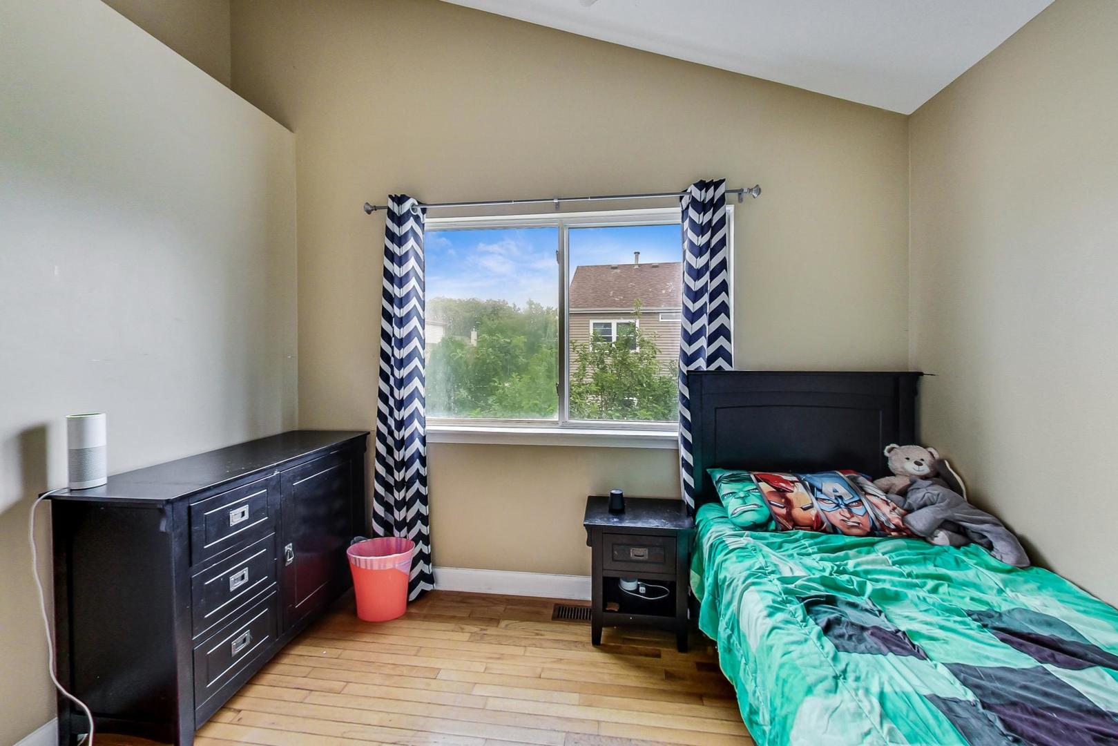 2385 North Periwinkle Way Round Lake Beach, IL 60073 - Photo 35 of 51 a bedroom with furniture and a wooden floor