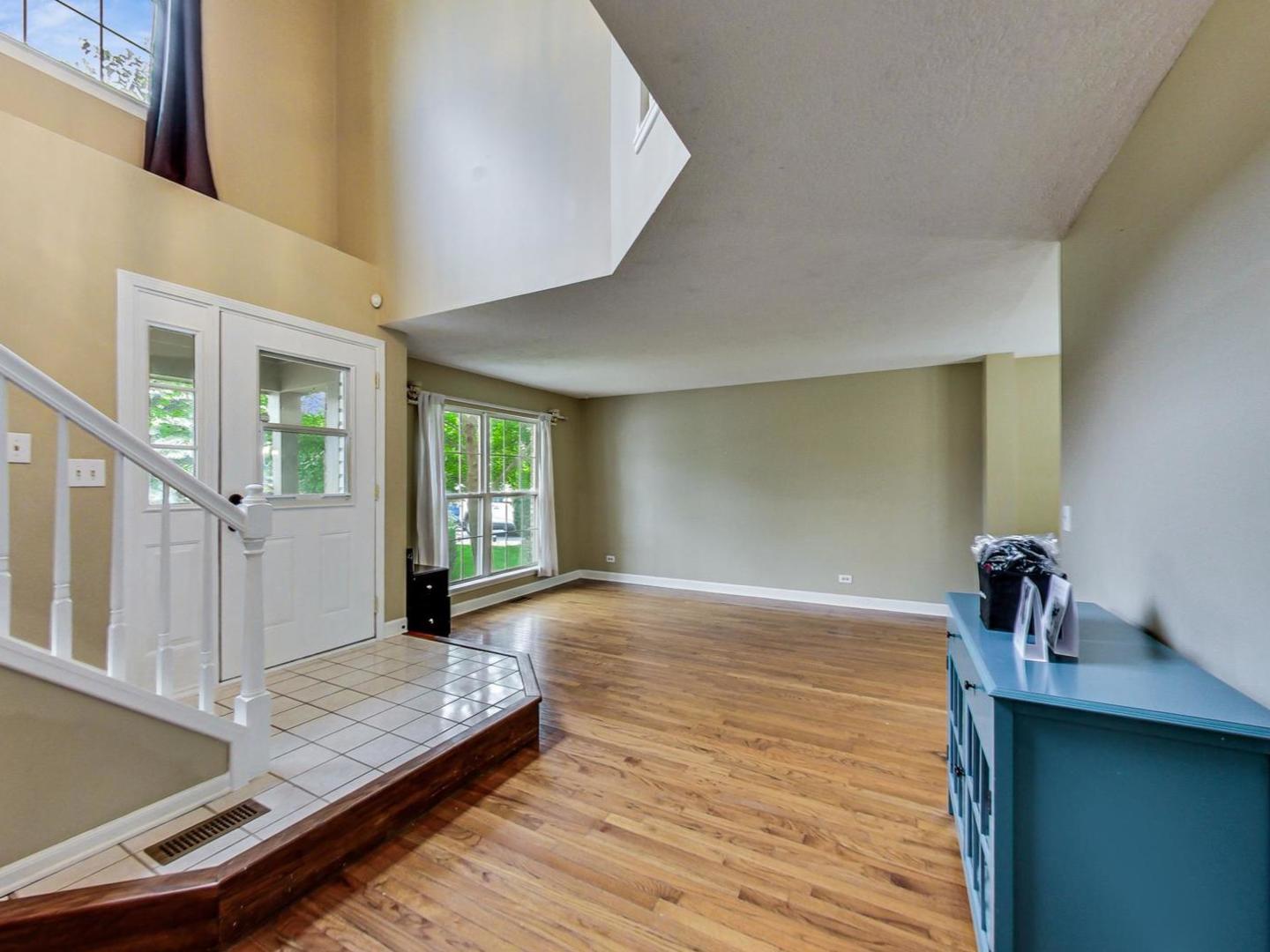 2385 North Periwinkle Way Round Lake Beach, IL 60073 - Photo 6 of 51 a view of an empty room with window and wooden floor