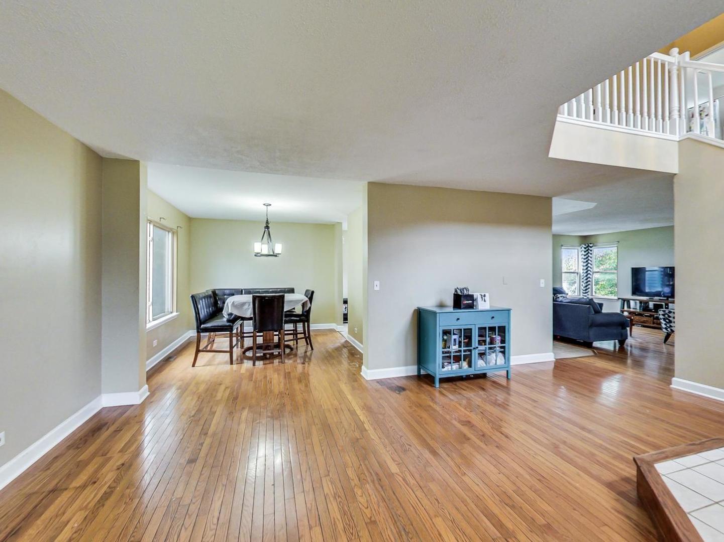 2385 North Periwinkle Way Round Lake Beach, IL 60073 - Photo 9 of 51 a living room with furniture and a wooden floor