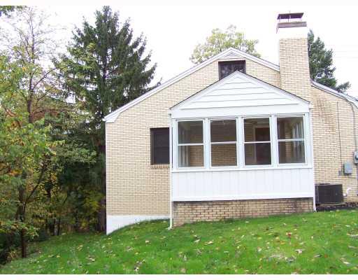 Exterior Front. Sunroom off living room  with ceiling fan