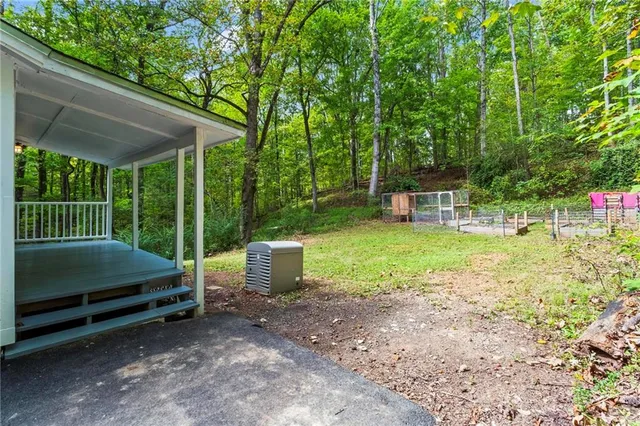 a view of a backyard with furniture and garden