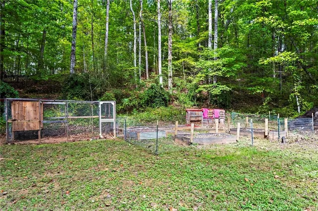 a view of house with a backyard