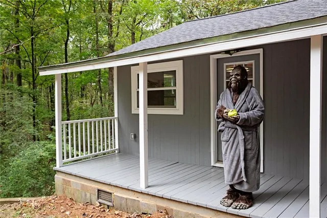 a view of a porch with a floor to ceiling window and potted plants