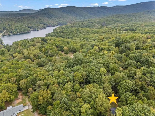 a view of a lush green hillside and houses