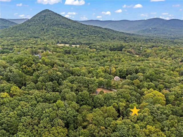 a view of a lush green hillside and a building