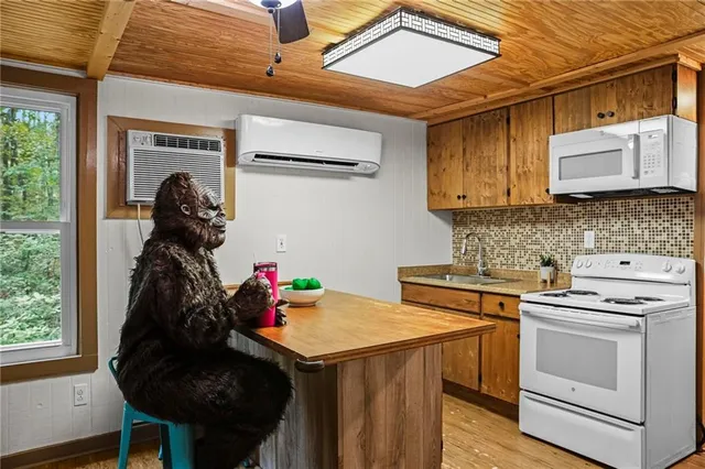 a kitchen with a sink cabinets and a stove