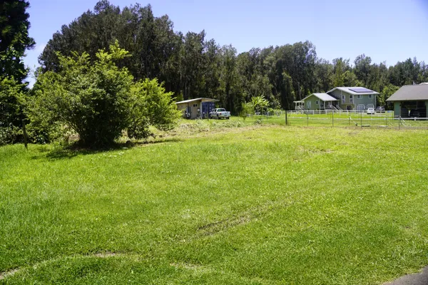 a view of a green field with sitting area