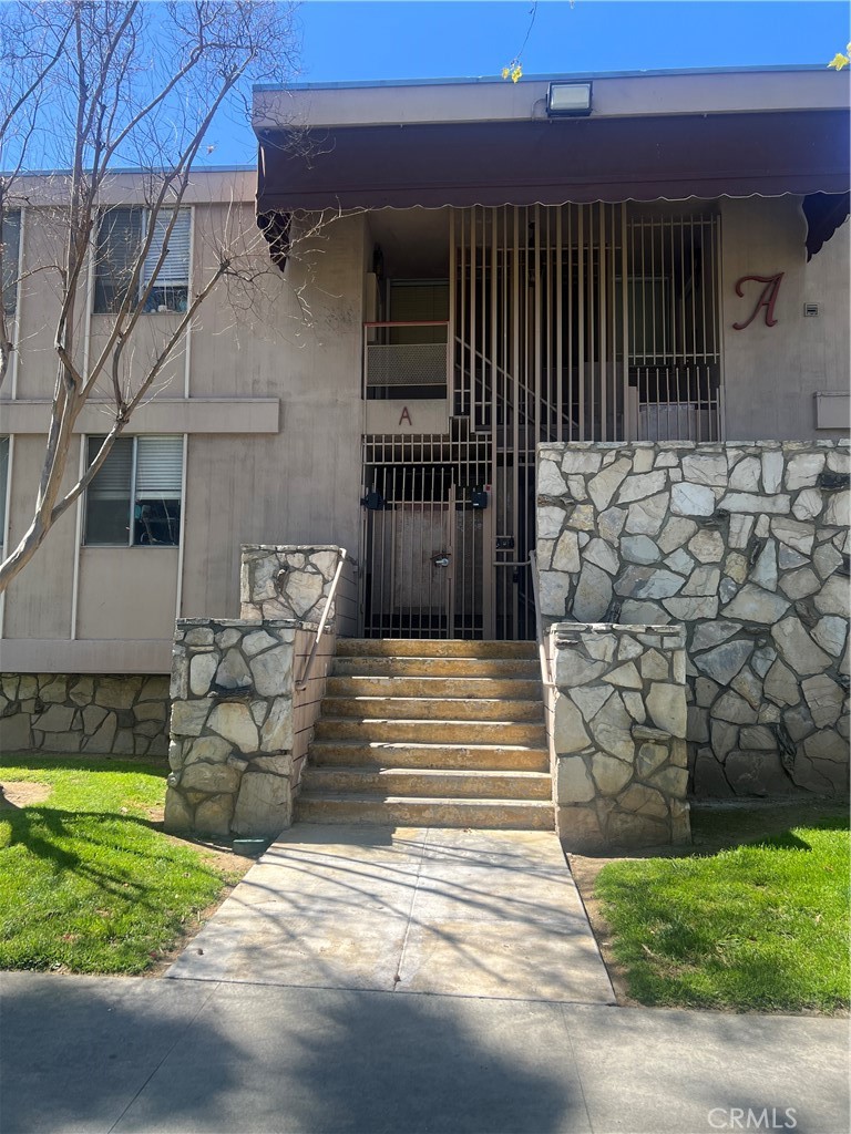 6979 Palm Court, Unit 204A Riverside, CA 92506 - Photo 1 of 6 a view of a patio with table and chairs with wooden fence