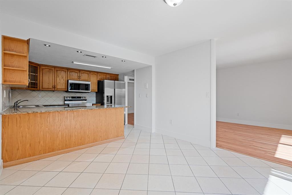 5700 Southwest 127th Avenue, Unit 1304 Miami, FL 33183 - Photo 12 of 42 a kitchen with stainless steel appliances a refrigerator sink and microwave