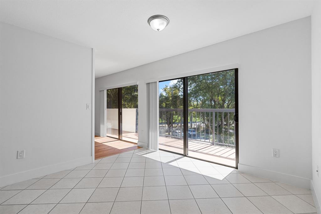 5700 Southwest 127th Avenue, Unit 1304 Miami, FL 33183 - Photo 14 of 42 a view of an empty room with a floor to ceiling window and an entryway