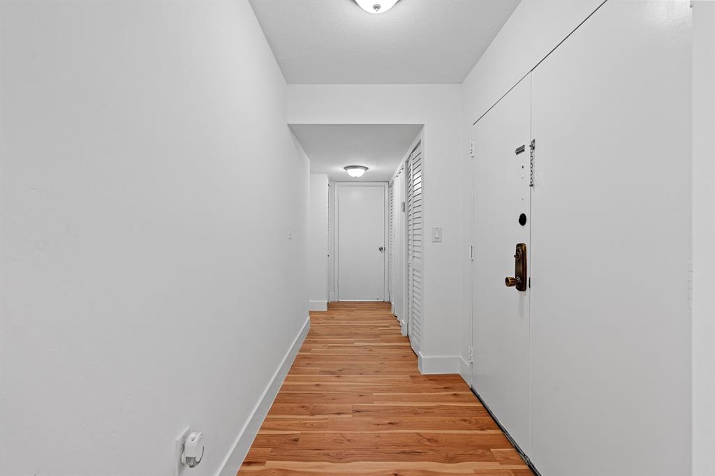 5700 Southwest 127th Avenue, Unit 1304 Miami, FL 33183 - Photo 19 of 42 a view of a hallway with wooden floor and a bathroom