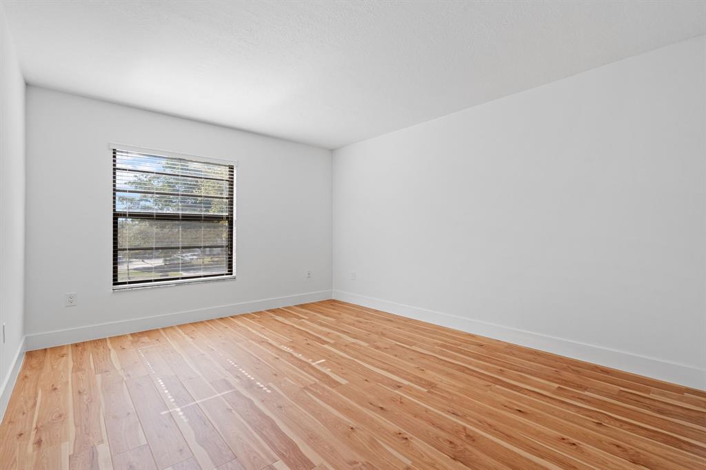 5700 Southwest 127th Avenue, Unit 1304 Miami, FL 33183 - Photo 23 of 42 a view of an empty room with wooden floor and a window