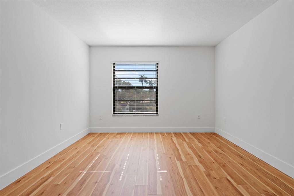 5700 Southwest 127th Avenue, Unit 1304 Miami, FL 33183 - Photo 24 of 42 a view of an empty room with wooden floor and a window