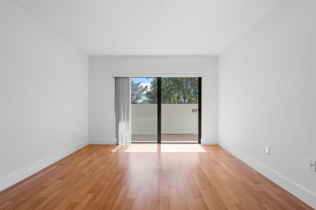5700 Southwest 127th Avenue, Unit 1304 Miami, FL 33183 - Photo 31 of 42 wooden floor in an empty room with a window
