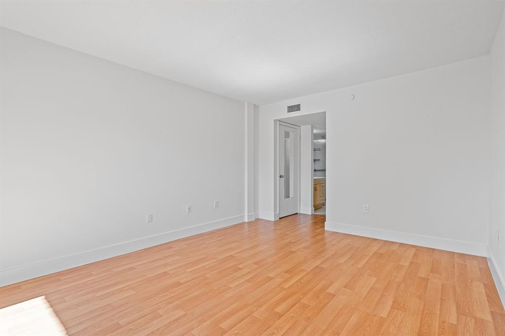 5700 Southwest 127th Avenue, Unit 1304 Miami, FL 33183 - Photo 32 of 42 a view of an empty room with wooden floor and a window