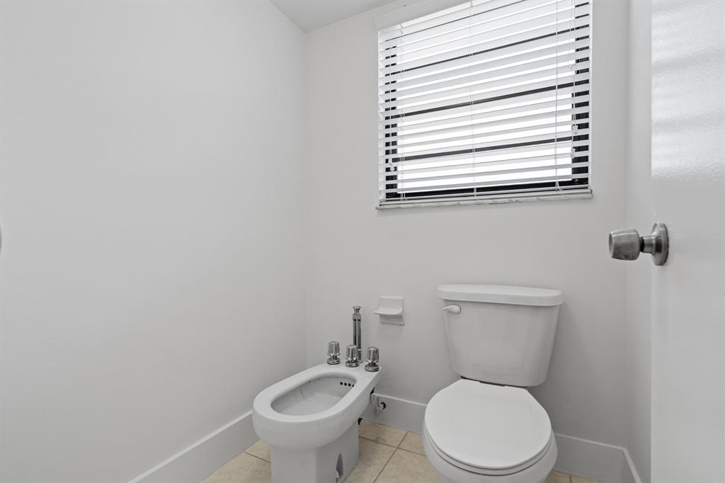 5700 Southwest 127th Avenue, Unit 1304 Miami, FL 33183 - Photo 35 of 42 a white toilet sitting next to a bathroom sink