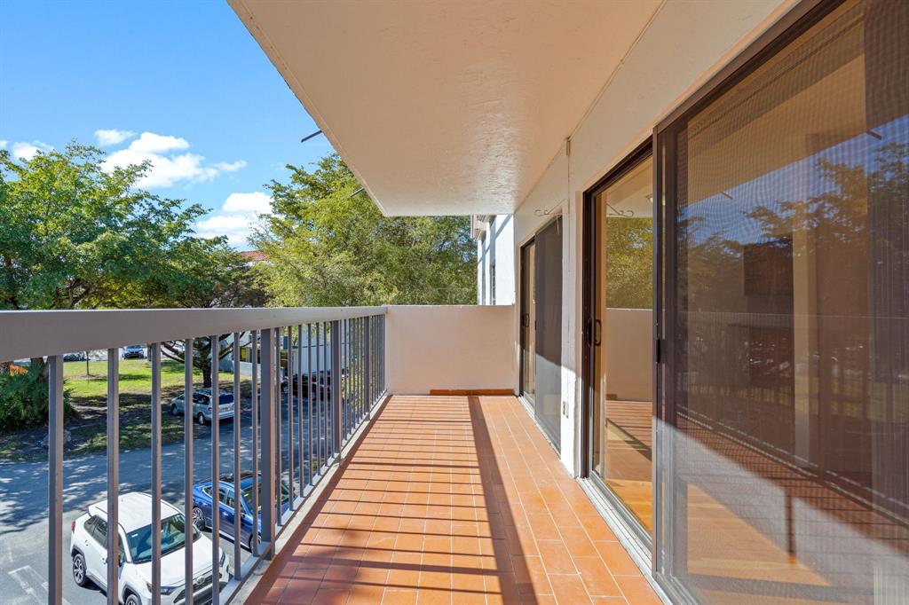5700 Southwest 127th Avenue, Unit 1304 Miami, FL 33183 - Photo 40 of 42 a balcony with wooden floor