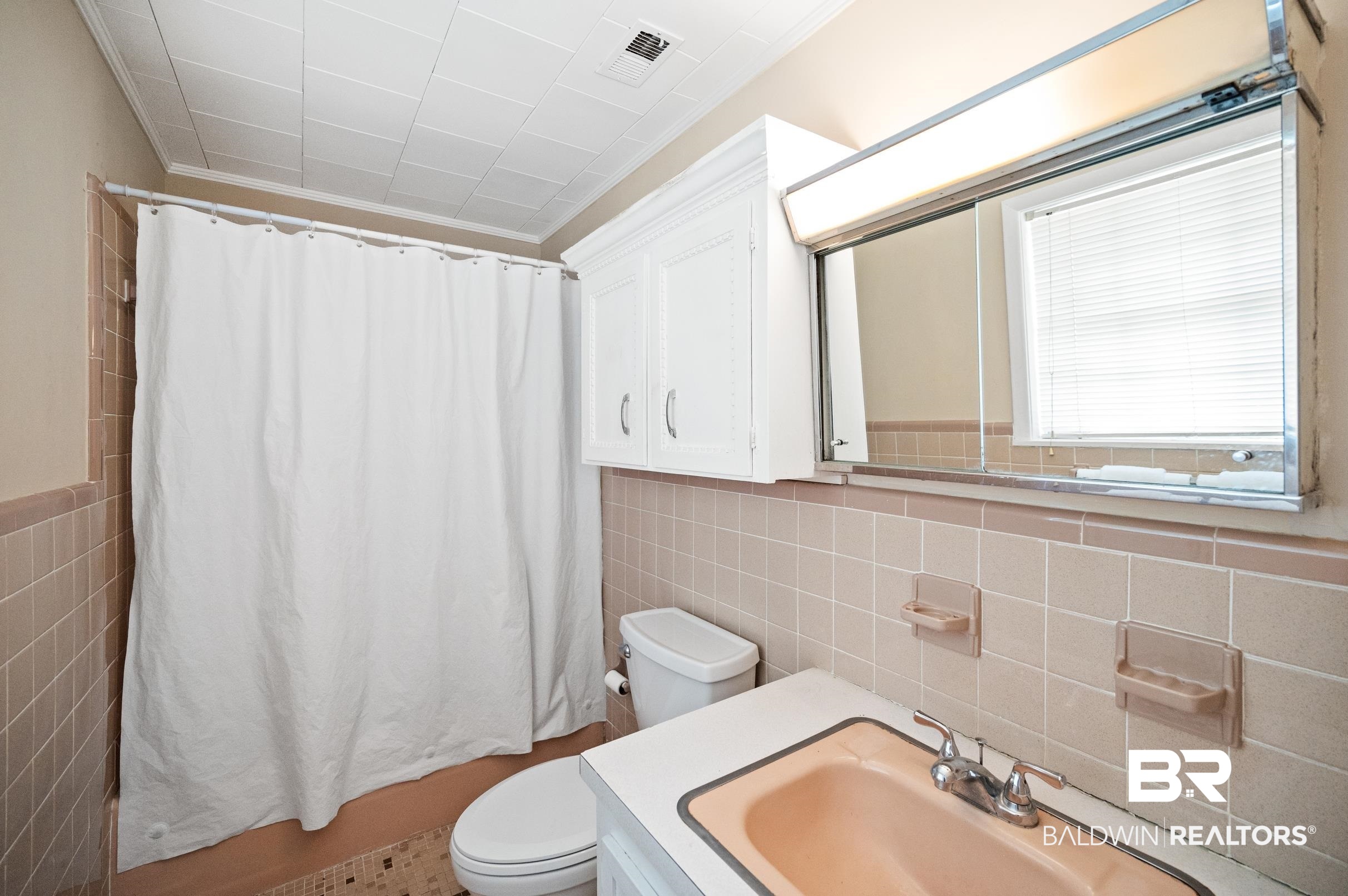15600 Fackler Road Loxley, AL 36551 - Photo 16 of 51 Bathroom featuring tile walls, vanity, and toilet