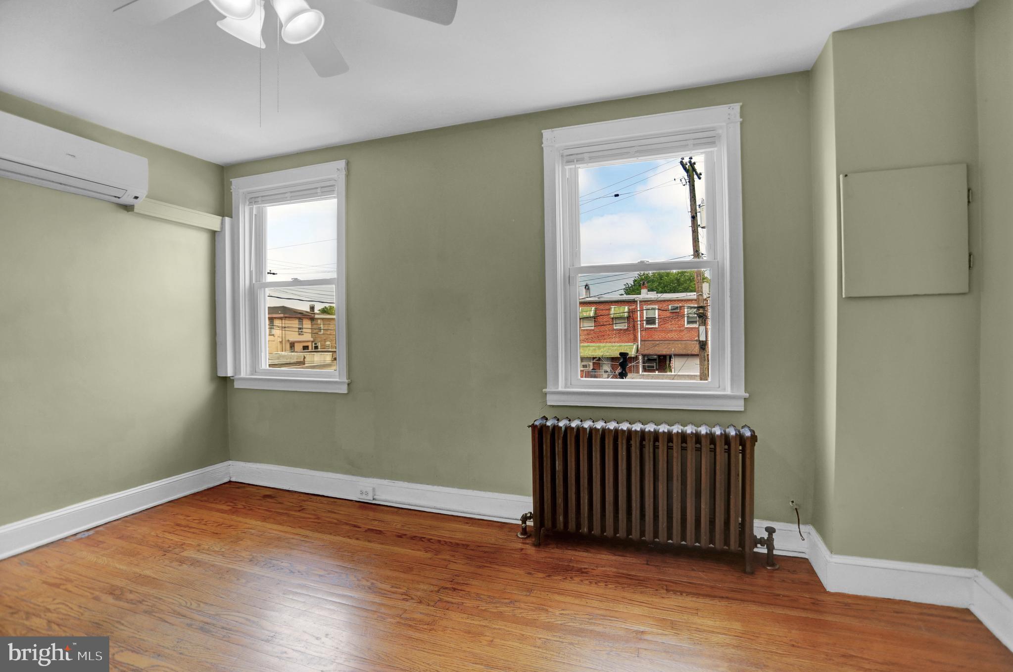 434 Folcroft Street, Unit A Baltimore, MD 21224 - Photo 12 of 22 a view of empty room with wooden floor and fan