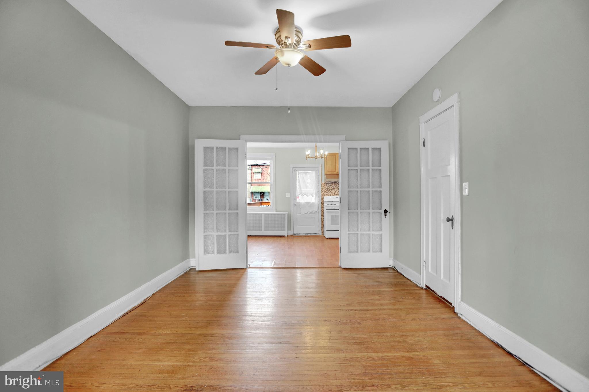 434 Folcroft Street, Unit A Baltimore, MD 21224 - Photo 15 of 22 a view of an empty room with window and wooden floor