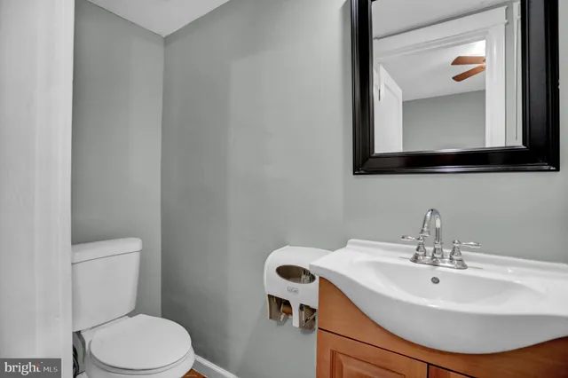 a bathroom with a sink a toilet and mirror