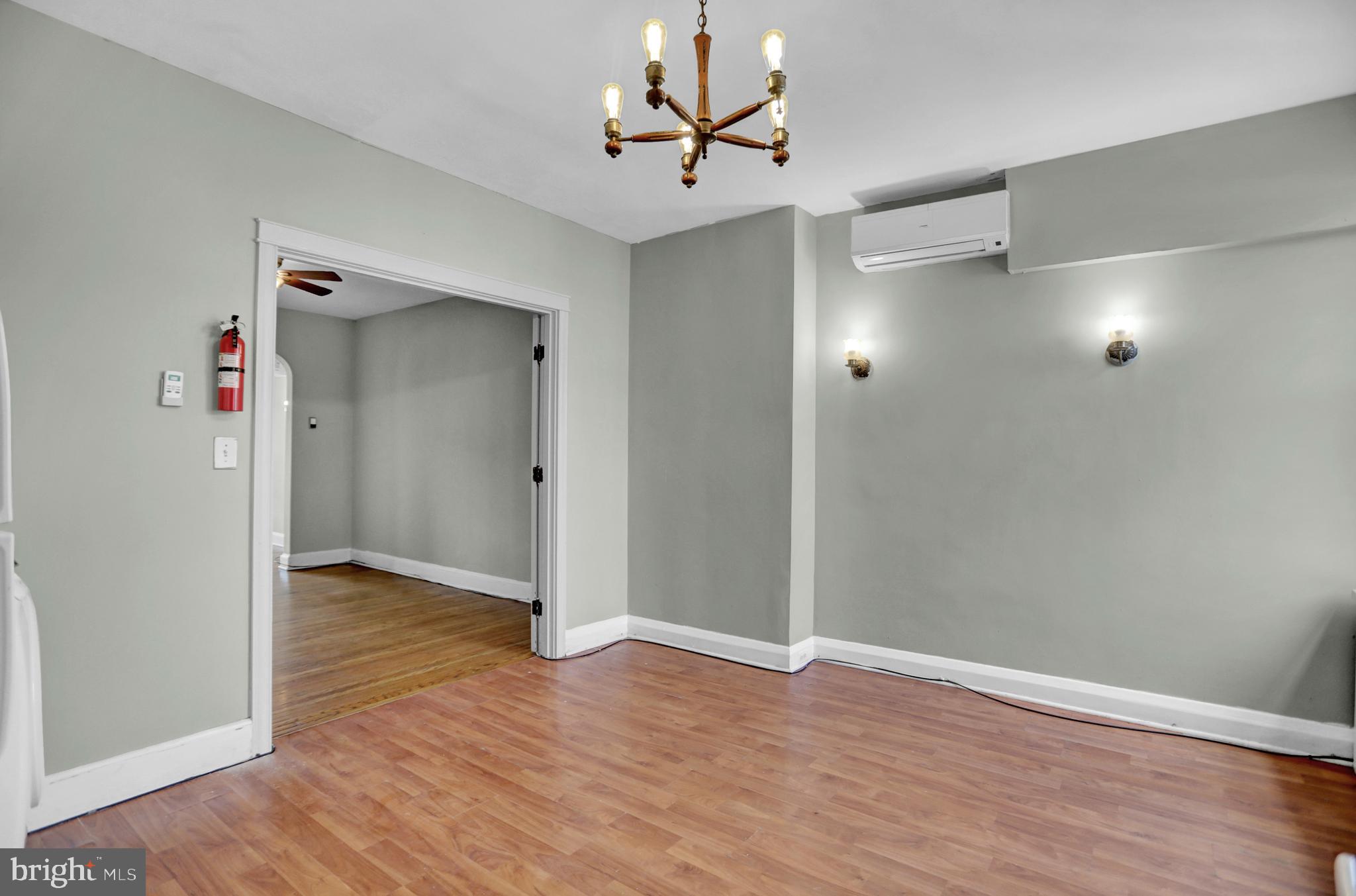 434 Folcroft Street, Unit A Baltimore, MD 21224 - Photo 19 of 22 an empty room with wooden floor and a ceiling fan