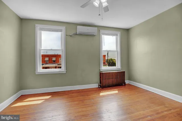 a room with a window and wooden floor