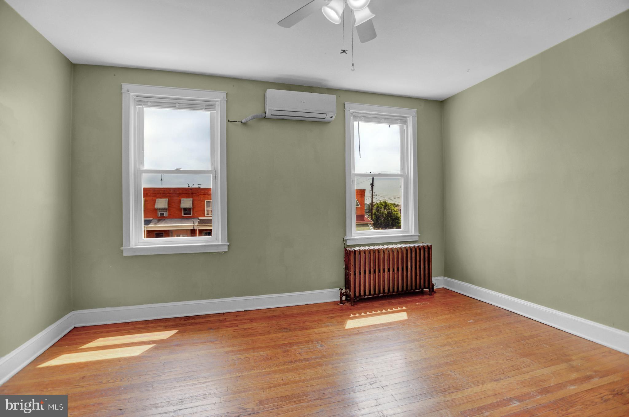 434 Folcroft Street, Unit A Baltimore, MD 21224 - Photo 8 of 22 a room with a window and wooden floor