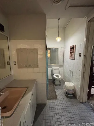 a bathroom with a sink a toilet and mirror