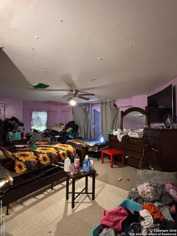 a living room filled with furniture and a flat screen tv