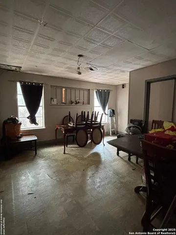 a living room with furniture a piano and a flat screen tv