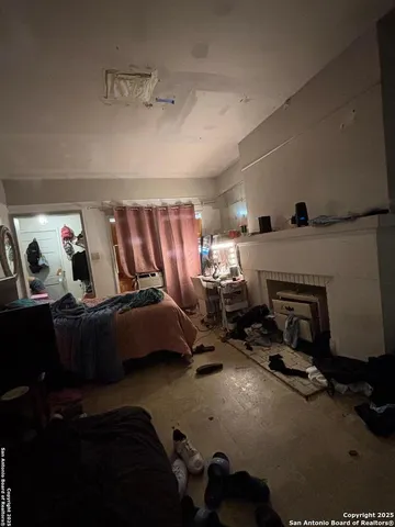 a living room with furniture gym equipment and a fireplace