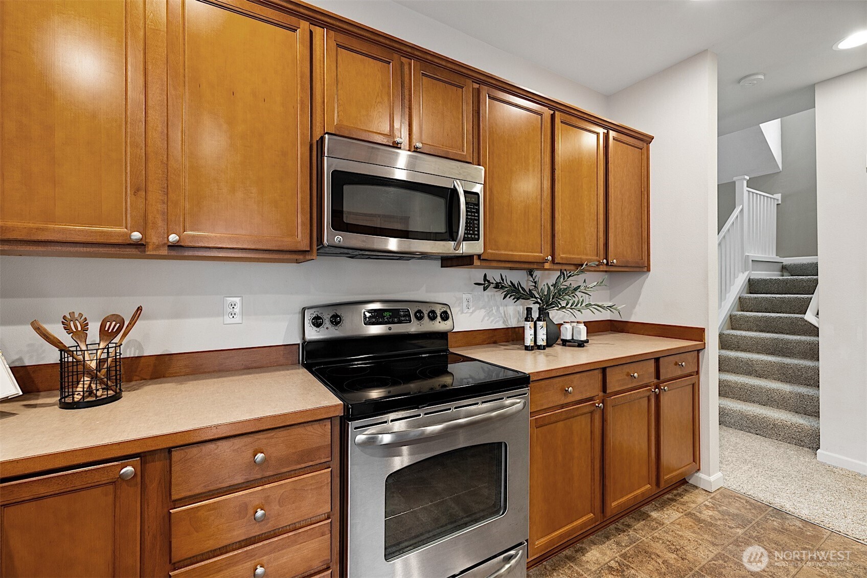 21509 48th Court South, Unit 181 Kent, WA 98032 - Photo 14 of 40 a kitchen with stainless steel appliances a stove a sink and cabinets