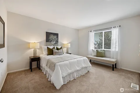 a bedroom with a bed and a window