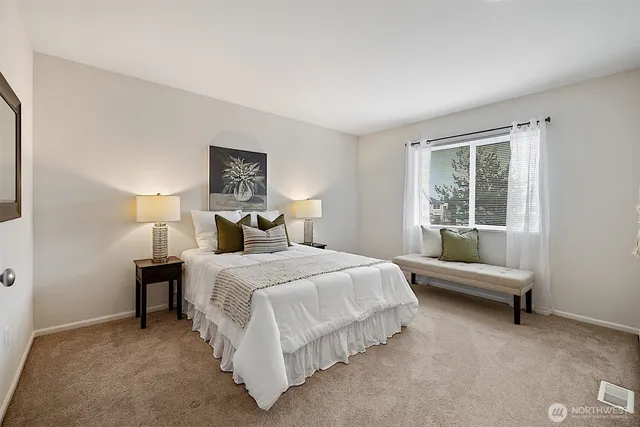 a bedroom with a bed and a window