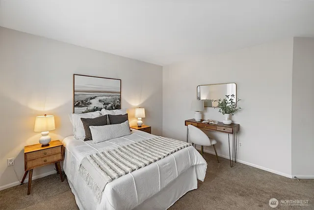 a bedroom with a bed and wooden table