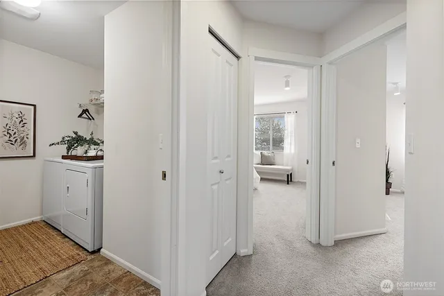 a view of a hallway with bathroom and a sink