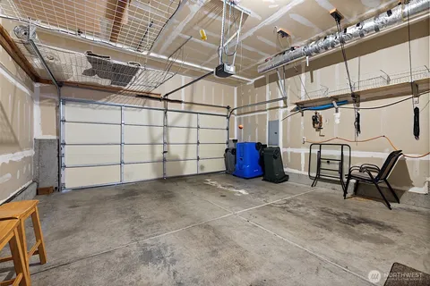 a view of a garage with wooden table and chairs