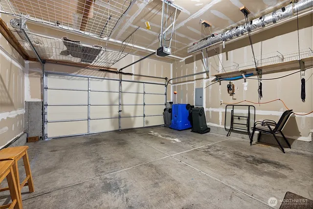 a view of a garage with wooden table and chairs