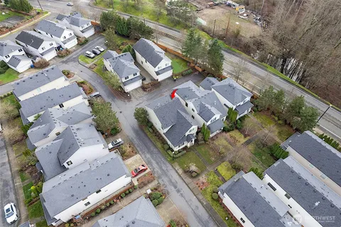 an aerial view of residential houses with outdoor space