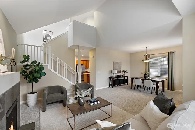 a living room with furniture potted plant and a window