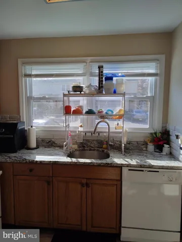 a kitchen with stainless steel appliances granite countertop a sink and cabinets