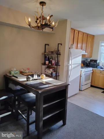 a kitchen with stainless steel appliances granite countertop a sink and a refrigerator