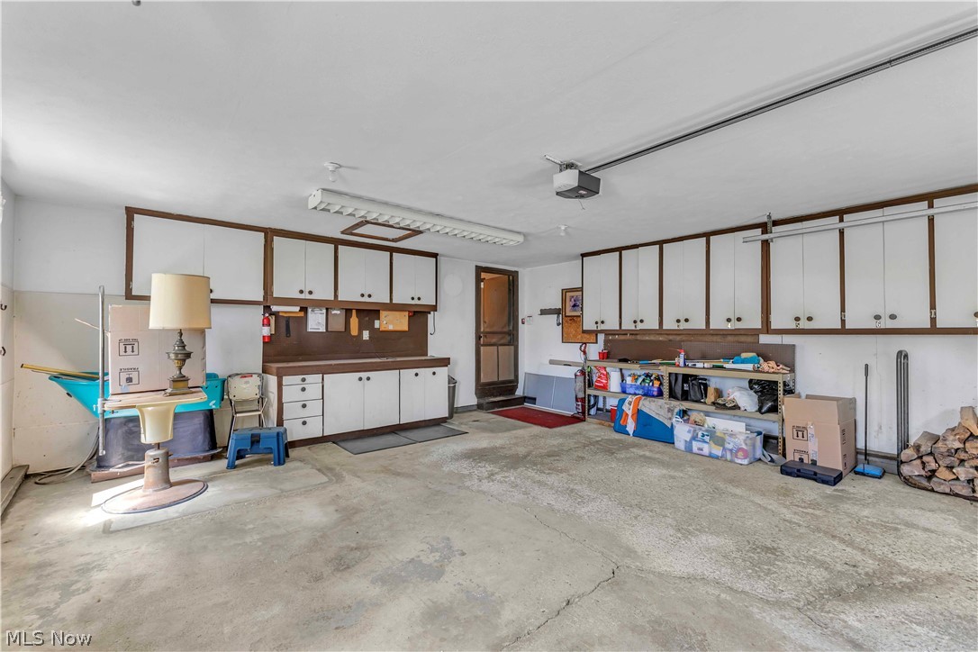 6635 Taylor Road Painesville, OH 44077 - Photo 35 of 41 Spacious garage featuring extensive built-in cabinetry, a work surface, and a concrete floor