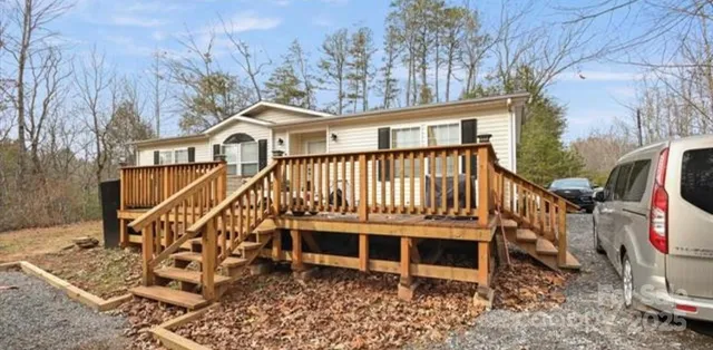 a view of a house with a wooden deck