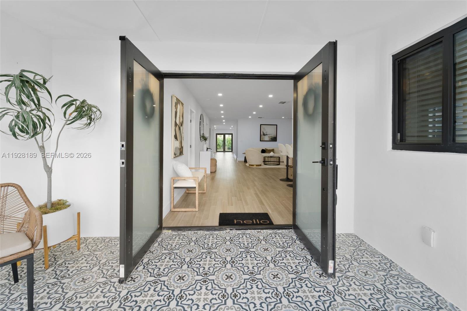a view of a hallway and a livingroom with furniture