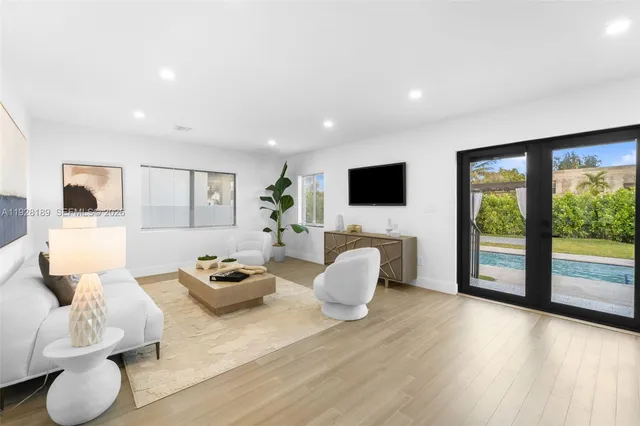 a living room with furniture and a flat screen tv